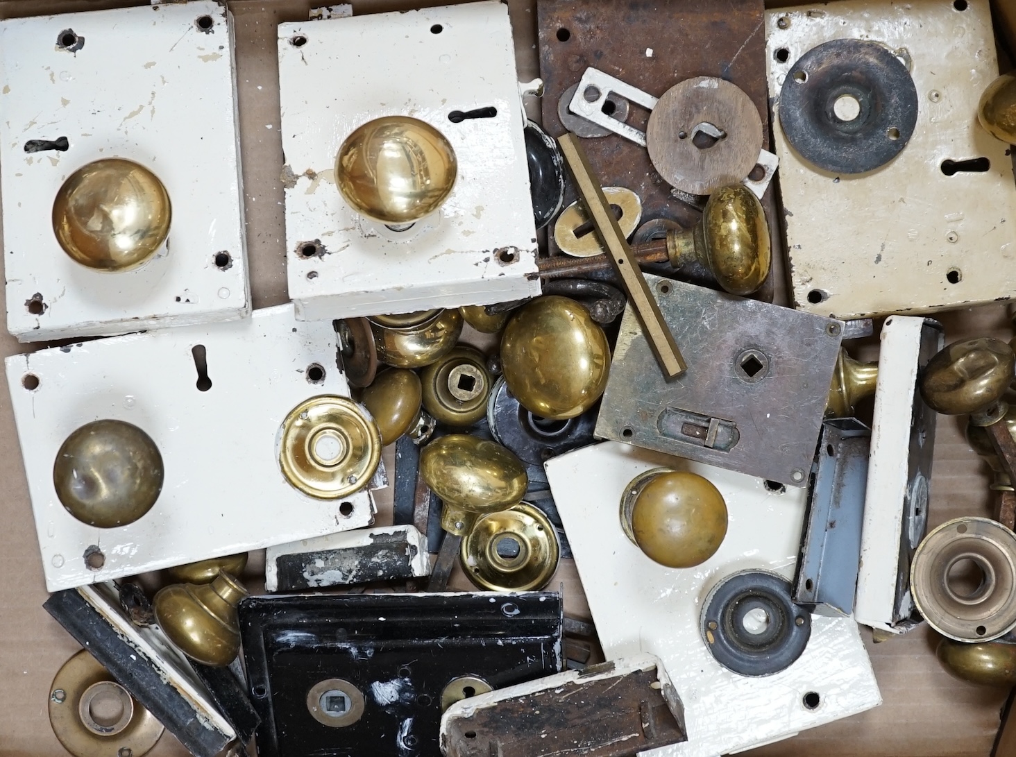A collection of door locks and brass knobs